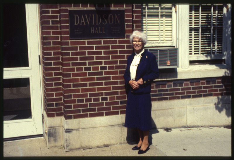 Margaret Davidson, daughter of J. Brownlee Davidson who was the founder of the Agricultural Engineering Department at Iowa State College. She is standing in front of Davidson Hall, her father's namesake, October 1988.