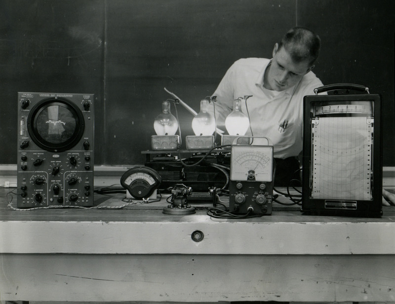 Bill Waters, agricultural engineering senior, learns electronic principles in the laboratory. An oscilloscope, and recording and indicating instruments, are used to show the characteristics of the circuits.