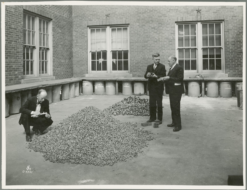 Chemical Engineering Professor W.E. Galligan, Ralph H. Suebbers, (graduate student) and Dr. Max Levine (Bacteriology) examine clay rings (produced in Ceramic Engineering Laboratory) for sewage-treatment filters as part of a general station study).