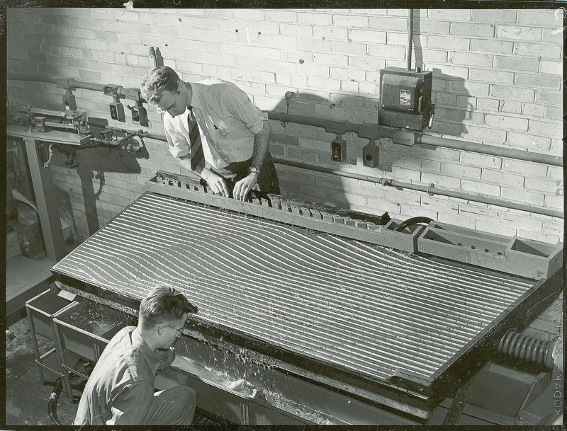 An Instructor and student run a test on sand and gravel using water and classification table.