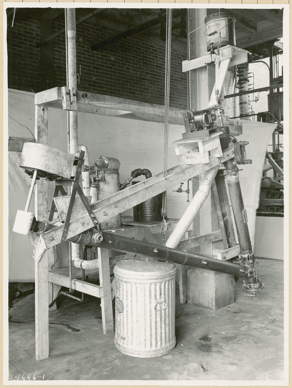 At the top of this apparatus is a five gallon can that reads "Amaizo, a superior oil from corn.".