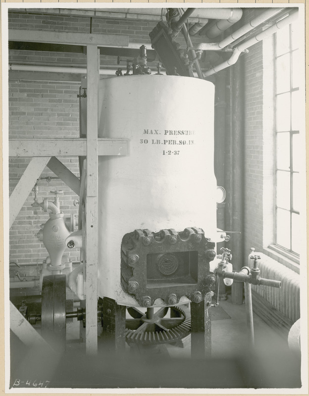 This stationary cooker installed in the Chemical Engineering Building was used to digest cornstalks for board production. The inscription on the cooker reads "Max pressure 50 lb. per sq. in, 1-2-37." Machine is part of project 158.