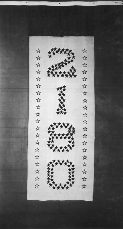 The Iowa State College Service Flag used in World War I. The numbers 2, 1, 8, 0 are arranged vertically on a white vertical field with a dark perimeter field. The numbers are formed by a double row of stars. At either side of the numerical inscription is a vertical line formed by a single row of stars.