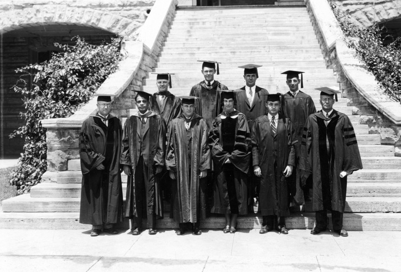 Wearing academic robes, the Botany Dept. faculty and Ph.D. graduates are standing on the steps of Botany Hall (Carrie Chapman Catt Hall). They are front row (left to right): Dr. I.E. Melhus, B.B. Mundkur, man unknown, Mary Frances Howe, man unknown, Dr. Martin? Back row (left to right): R.H. Porter?, H. C. Murphy, W. F. Buckholz, and Mardy H. Berberian.