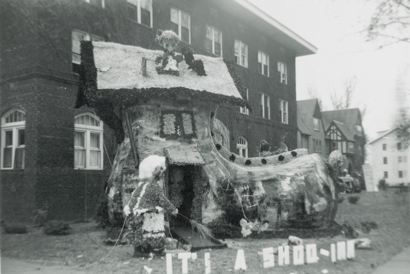 The theme for this display from the Phi Delta Theta, Iowa Gamma Chapter is a large shoe home suggesting the nursery rhyme There Was an Old Woman Who Lived In a Shoe. The accompanying sign reads, "It's a shoo-in.".