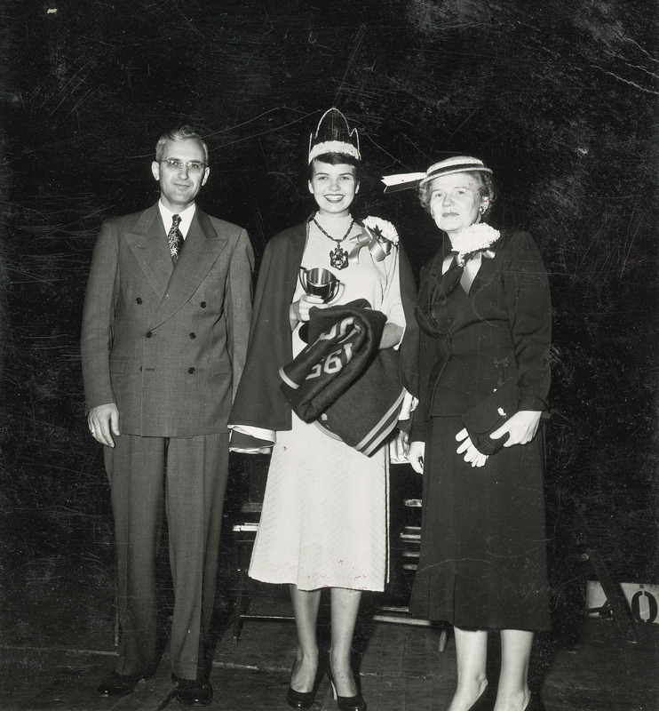 The 1953 Homecoming queen, Pat Nelson stands between her parents, Reverend and Mrs. Nelson of Luverne, Minnesota.