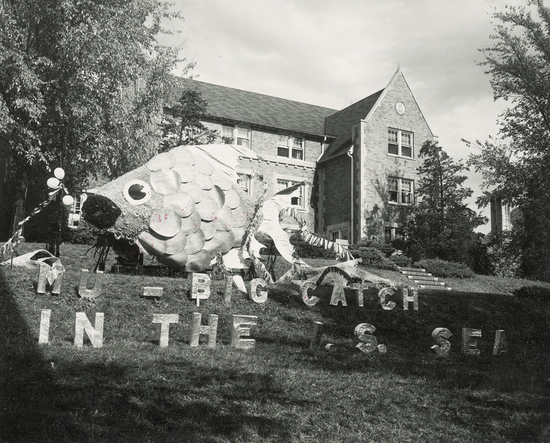 The Alpha Delta Pi lawn display for 1953, features a large scaled fish. Separate letters in front of the fish read, " M U--big catch in the I S Sea.".