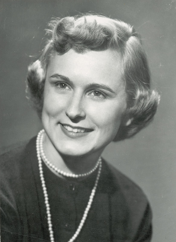 In this formal portrait Homecoming queen, Doris Woessner is wearing a dark outfit and a pearl necklace.