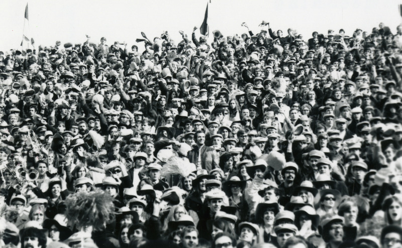 A crowd of homecoming spectators watching an event, probably the football game.