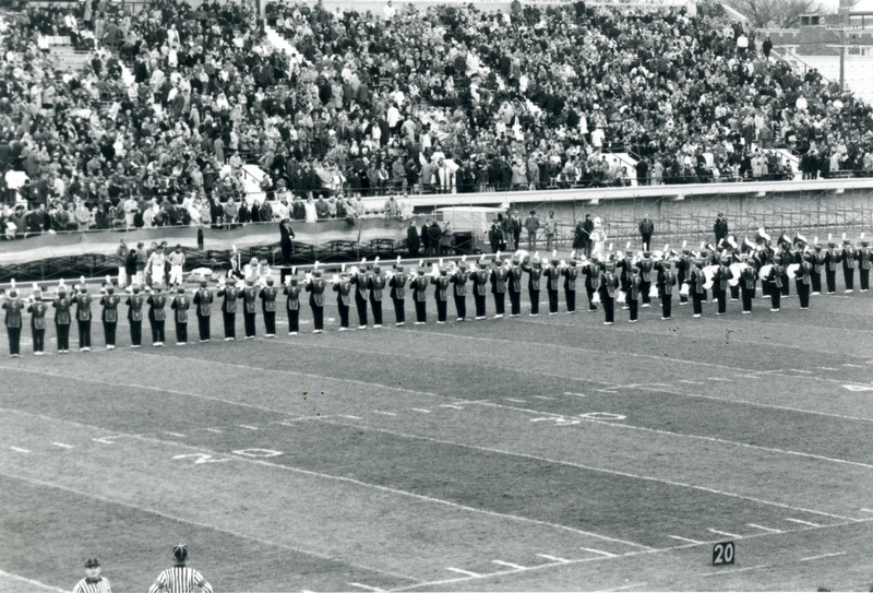 The ISU Marching Band is performing before the crowd at the 1970 Homecoming football game.