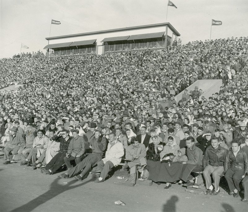 Students are sitting in the stadium at Clyde Williams Field for the Homecoming Football Game in 1948.