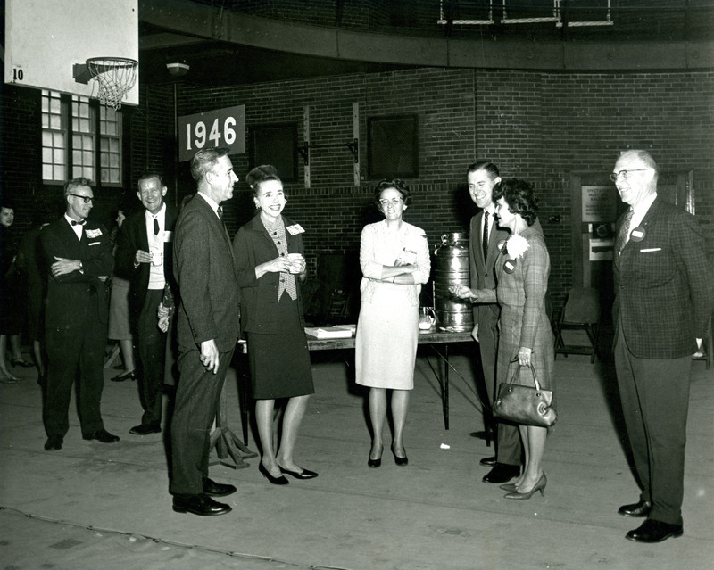 Presidents Parks chats with members of the class of 1946 and enjoys refreshments at Homecoming, October 15, 1966. President Parks is below the "1946" sign, and to the right is Cornelia "Nikki" Lindstrom Buck, BS FLS, 1946, and MS FLS, 1972.