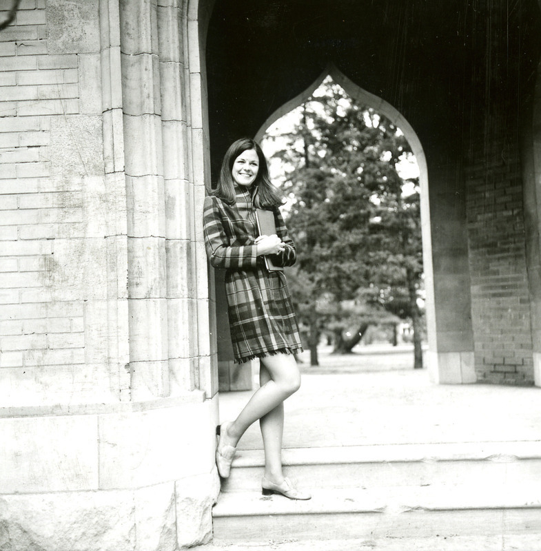 Nancy Chase, 1968 Homecoming Queen, poses next to a doorway of the campanile.