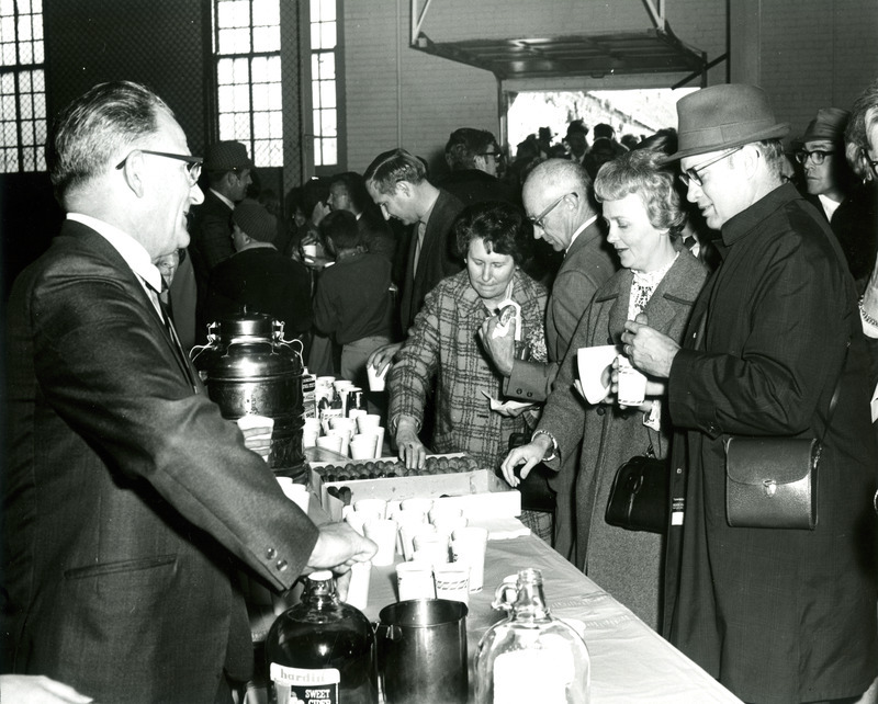 Alumni are served coffee and donuts at the Homecoming Reception in the State Gym, 1968.