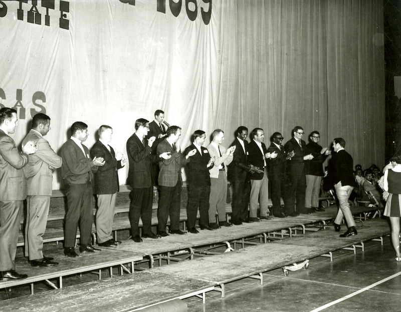 Special alumni are called on stage during the Pep Rally on the night before Homecoming, 1969.