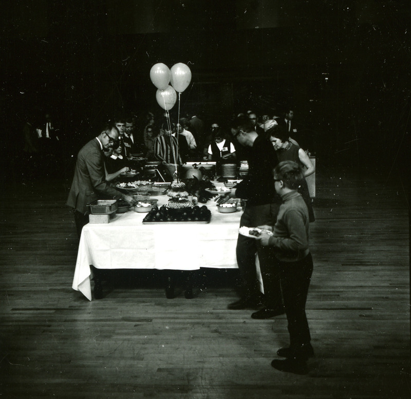 Alumni line both sides of the buffet at the Homecoming Banquet, 1969.