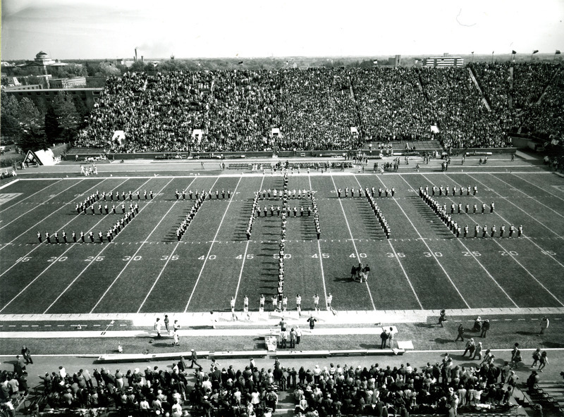 The ISU Marching Band forms the word "State" on the football field at Homecoming, October 19, 1974.