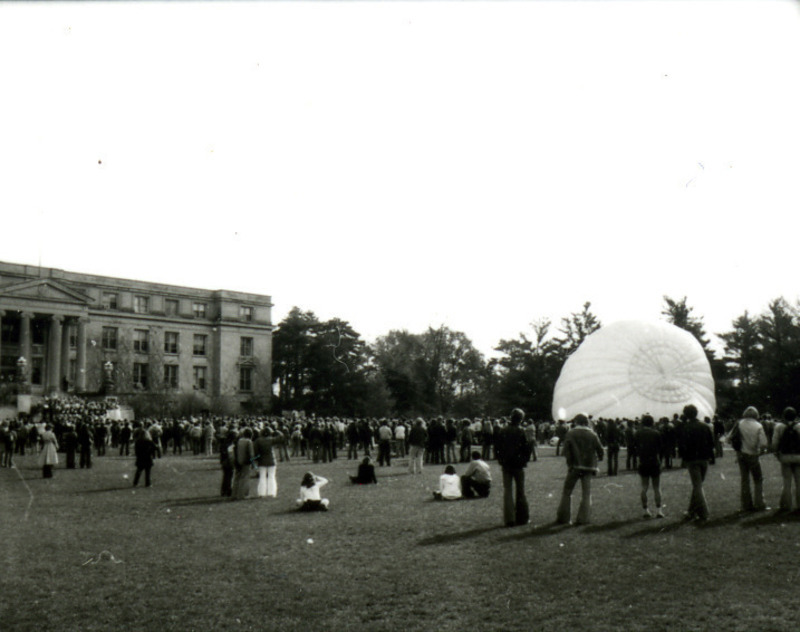 A hot air balloon is being filled with air in the background during the Homecoming Pep Rally on Central Campus, 1977.