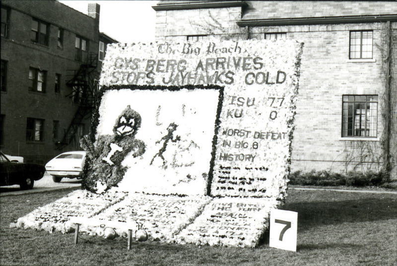 A Homecoming lawn display shows the Des Moines Register Big Peach sports page announcing "Cy's Berg Arrives; Stops Jayhawks Cold," 1977. This is in reference to the International Conference on Iceberg Utilization that took place in Ames in October 1977.