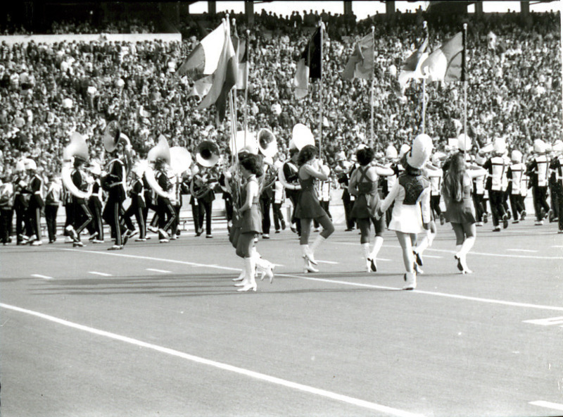 The ISU Color Guard is shown performing with the Marching Band on the football field for Homecoming, 1977.