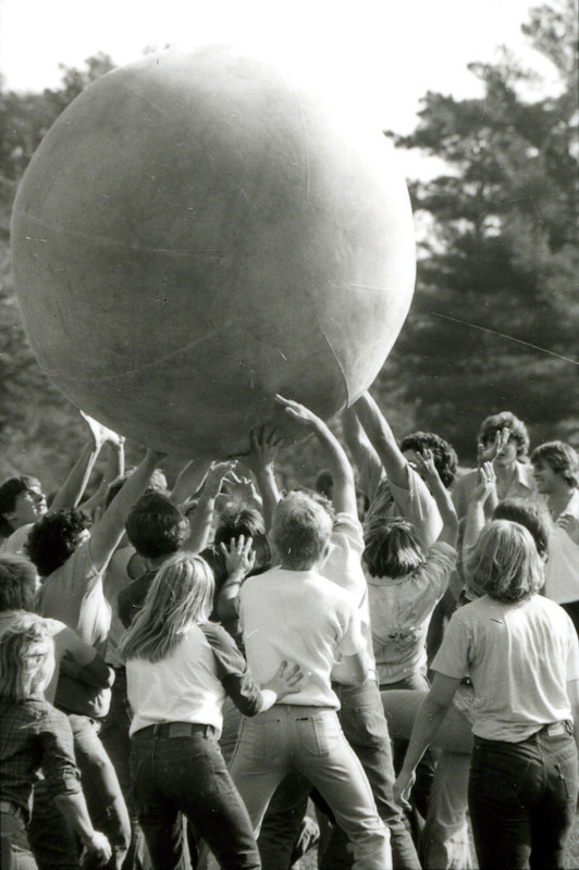 Many hands lift the push-ball above the crowd in a game on Central Campus as part of Homecoming, 1978.