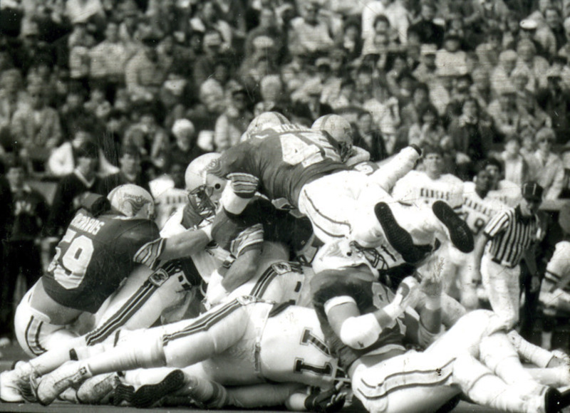 Iowa State football players pile on top of Kansas players at the Homecoming game, 1985.