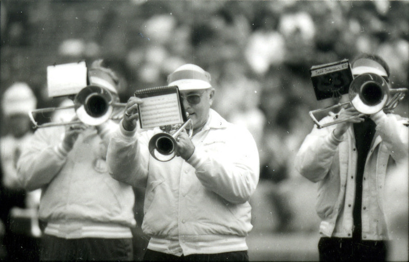 A trumpet player and two trombone players march in the ISU Alumni Band at Homecoming, 1985.