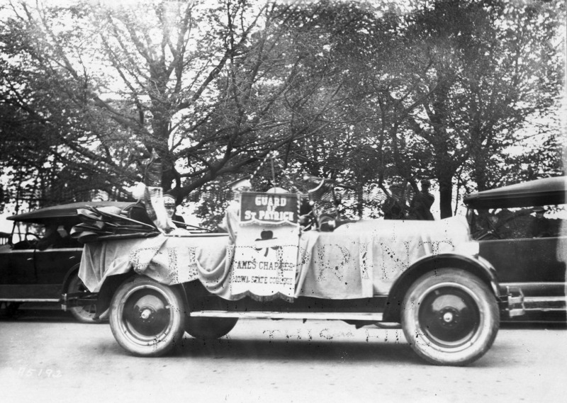 1923 automobile float with banner "Guard of St Patrick. Ames Chapter Iowa State College.".