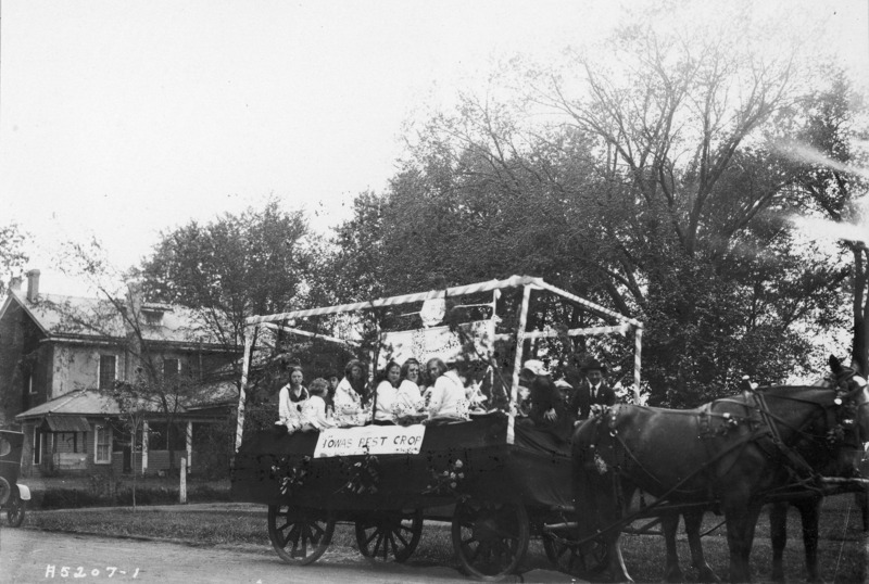 1923 horse-drawn float "Iowa Best Crop." Several young women are seated on the float.