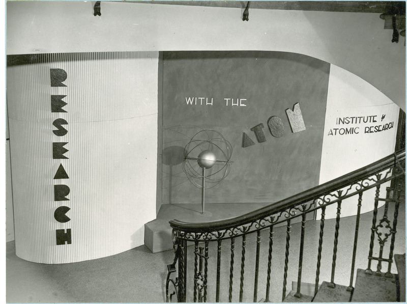 VEISHEA open house exhibit for the Institute for Atomic Research. A model of an atom is situated on a platform.