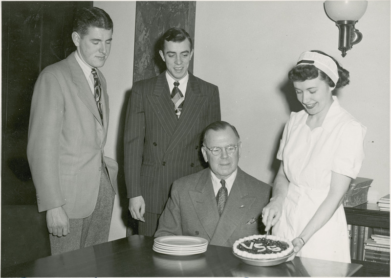 President Charles E. Friley, being served a slice of cherry pie. The VEISHEA cherry pies are a long standing tradition. Pie baking and sales are managed by students in the Hotel, Restaurant, and Institution management.