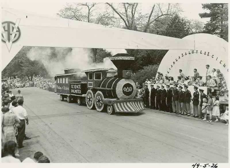 A 1949 VEISHEA parade float. Phi Delta Theta's locomotive steams under the VEISHEA Arch to win the sweepstakes trophy.