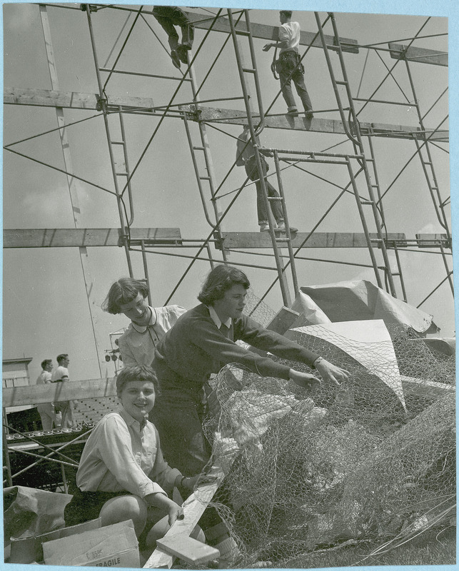 Three women and five men work on the outdoor stage for the Stars Over VEISHEA performance. The Nite Show is the predecessor to Stars Over VEISHEA.