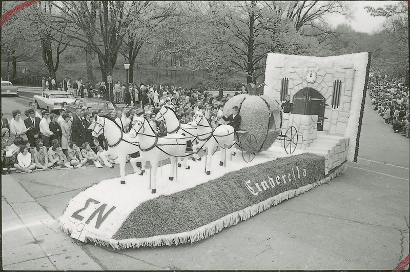 A 1967 VEISHEA parade float. The Sigma Nu float "Cinderella" depicts Cinderella's pumpkin carriage being drawn by four horses away from the castle at midnight.