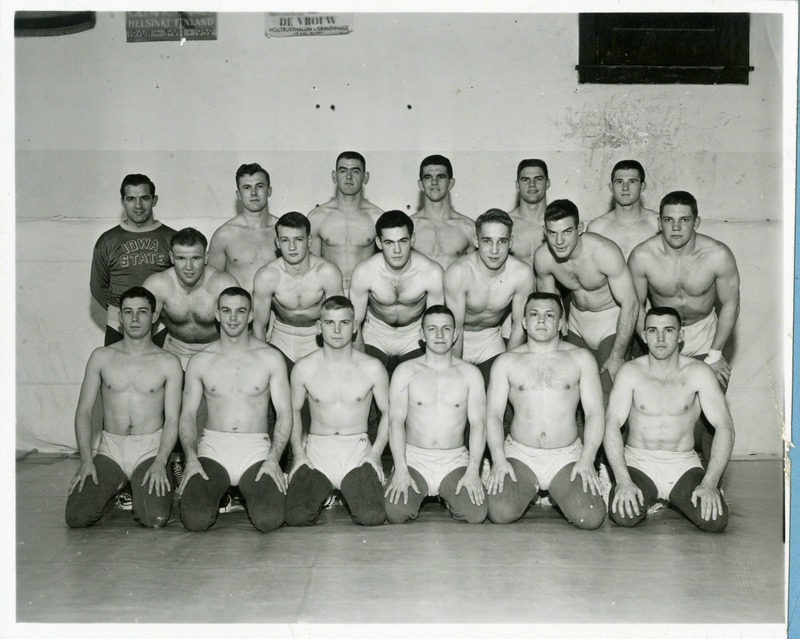 The 1954 members of the Iowa State University wrestling team are: Front row, left to right: Gene Dale, Sam Ruzie, Jack Kier, Robert Lewis, Fred Benttler, Merrill Smalley. Second row, left to right: Ronald Larsen, Hugh Linn, Benjamin Bernard, Robert Formanek, Bill Nordike, Russell Johnston. Third row, left to right: Coach Harold Nichols, Don McCormick, Harold Hanningsen, Connie Gerdes, Elmer May, Don Ellingson.