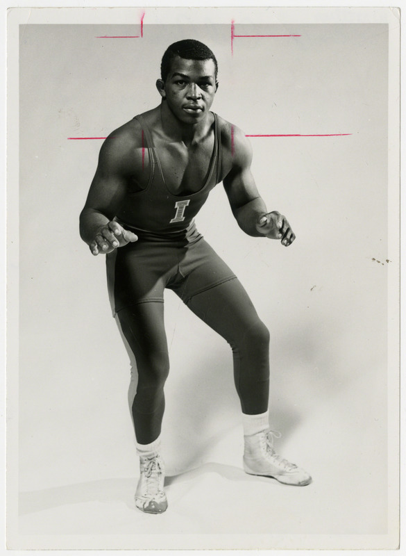 Carl Adams, Iowa State University wrestler, poses for portrait in ready position, 1969-1972.