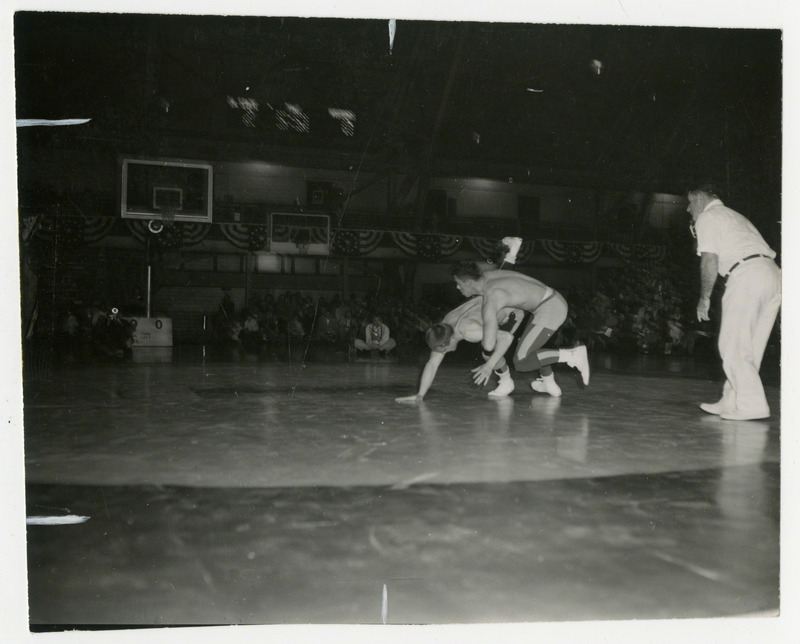 Ron Gray (right) grapples with Jerry Frude (left).