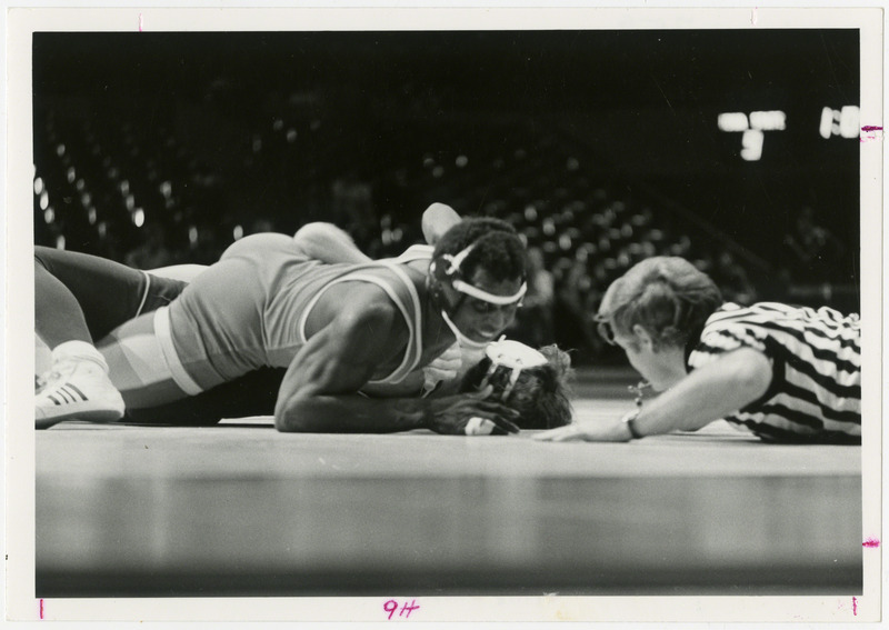 Willie Gadson pins down wrestling opponent.