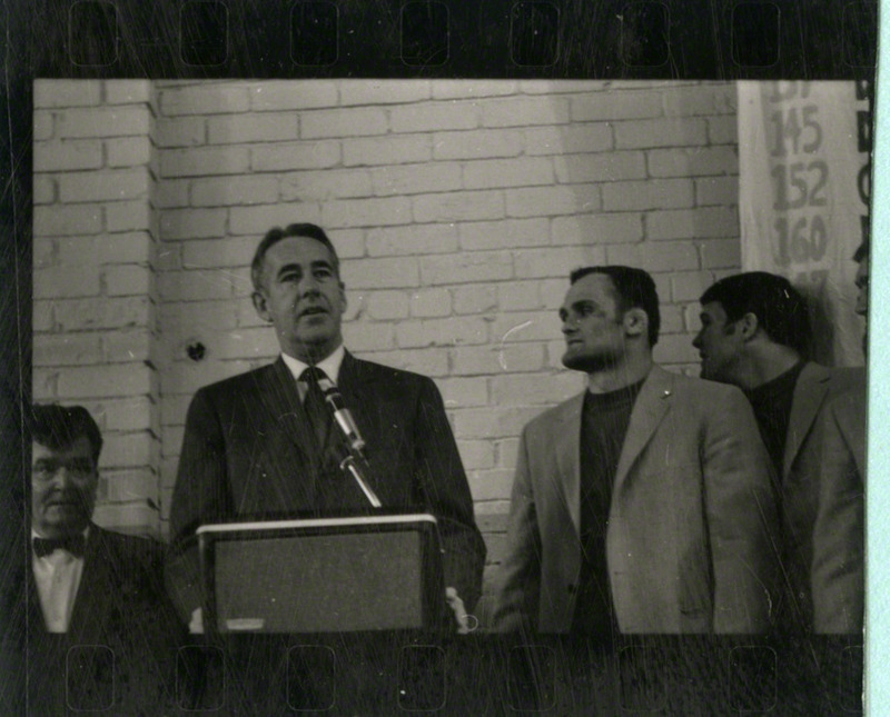 An unidentified man is speaking behind a podium.