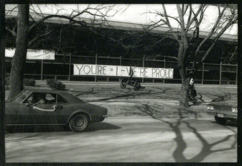 A cannon and banner are seen. "You're #1--We're Proud".