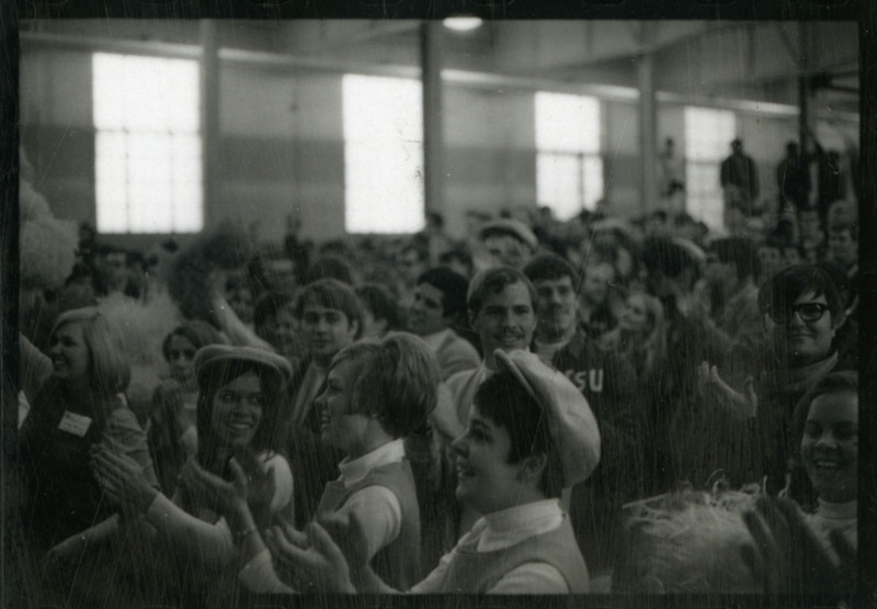 The crowd cheers, presumably for the 1969 Iowa State University Wrestling Team.