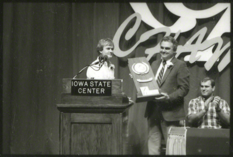 An unidentified man is accepting an award.