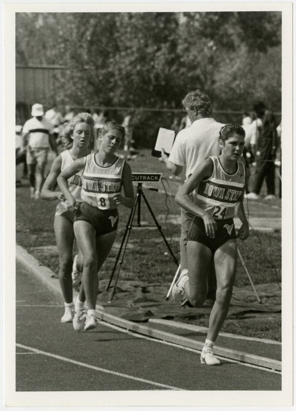 Three women runners, including two Iowa State University, compete in race at a track competition, 1986.