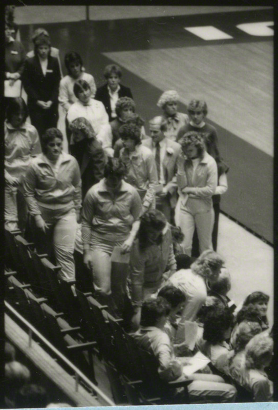 The women's cross-country team members are preparing to sit before the memorial service begins.