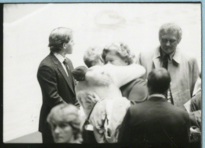 Two woman are comforting each other at the conclusion of the memorial service, 1985.