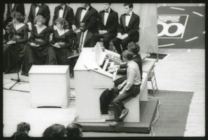 The Iowa State University Chamber Singers are seated as Lynn Zeigler-Dickson plays the organ during the memorial service, 1985.