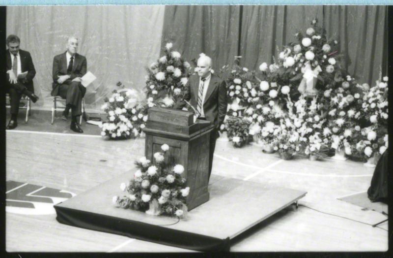 Tom Lichtenberg is at the podium giving a eulogy for cross-country runner, Julie Rose, 1985.