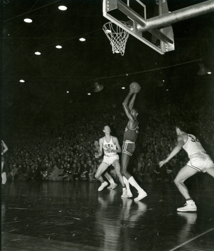 Wilt Chamberlain (Kansas #13) prepares to pass.