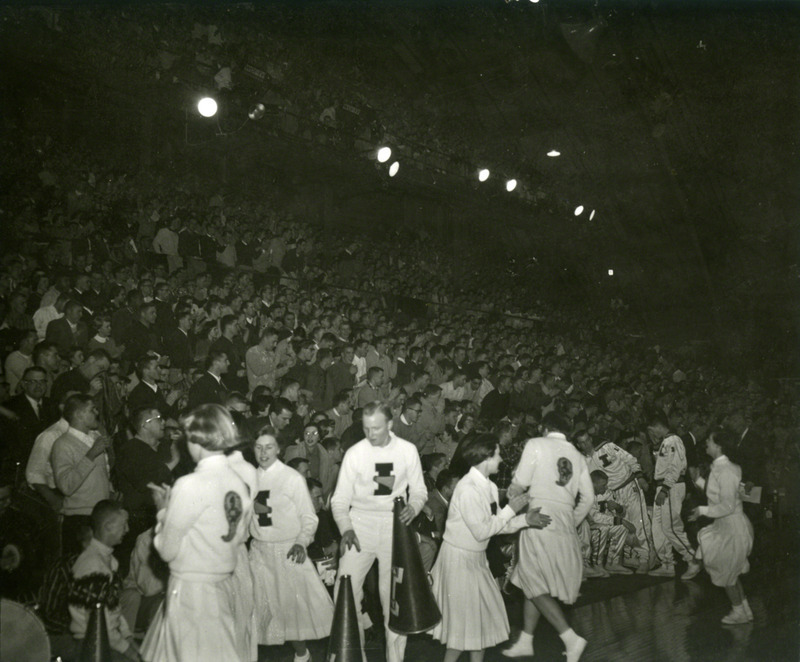 Iowa State cheerleaders in front of the stands.