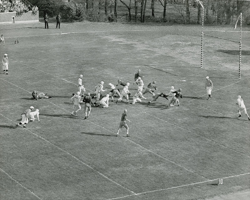 A football game in progress between Iowa State University and Oklahoma. The viewpoint is from the upper part of the stadium.